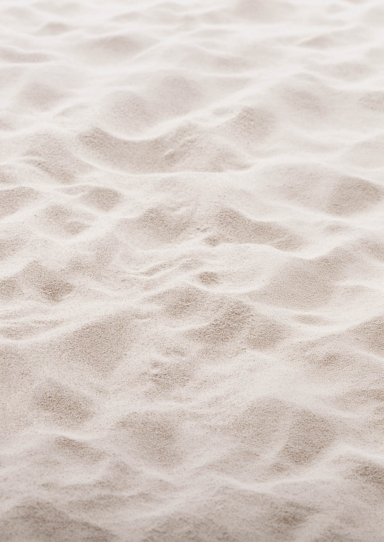 Fine Sand texture natural surface. Close up of sand on shore sea, white waves dunes, pink neutral color, minimal nature aesthetics wallpaper. Sandy beach for background, selective focus, copy space.